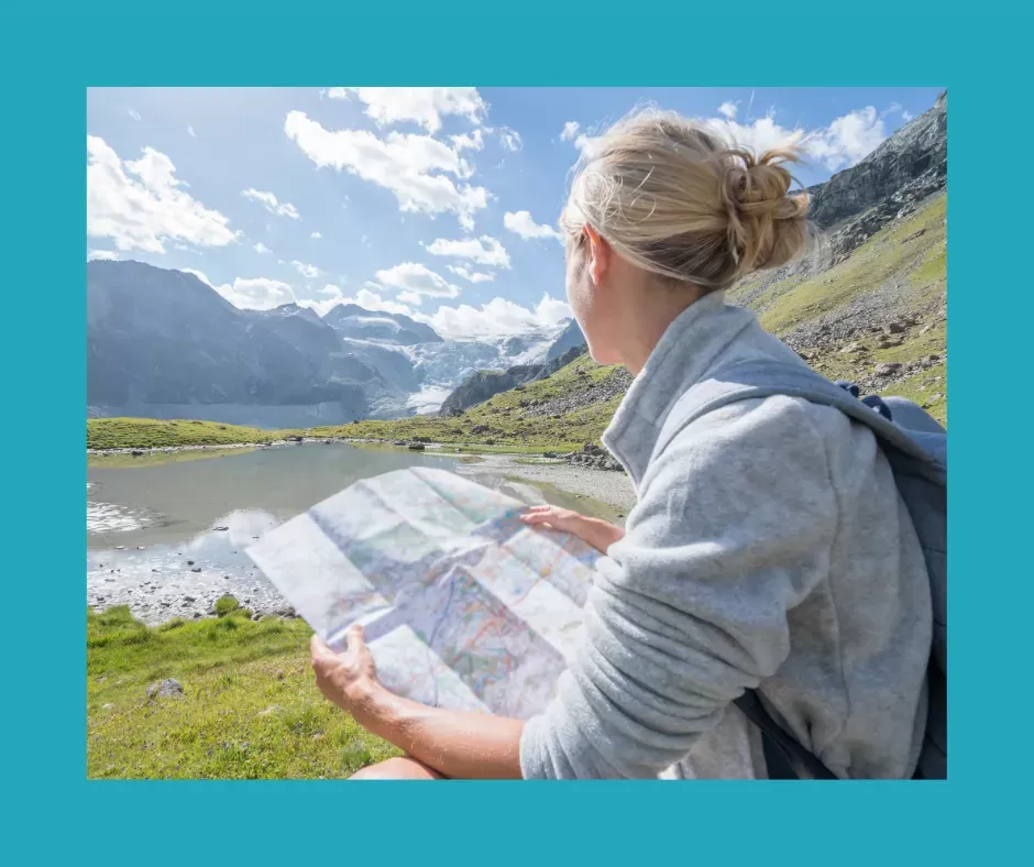 Woman in mountains with map